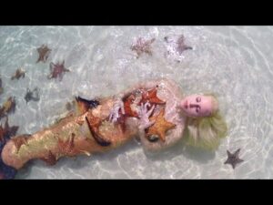 Mermaid Melissa with real sea stars on Starfish Island
